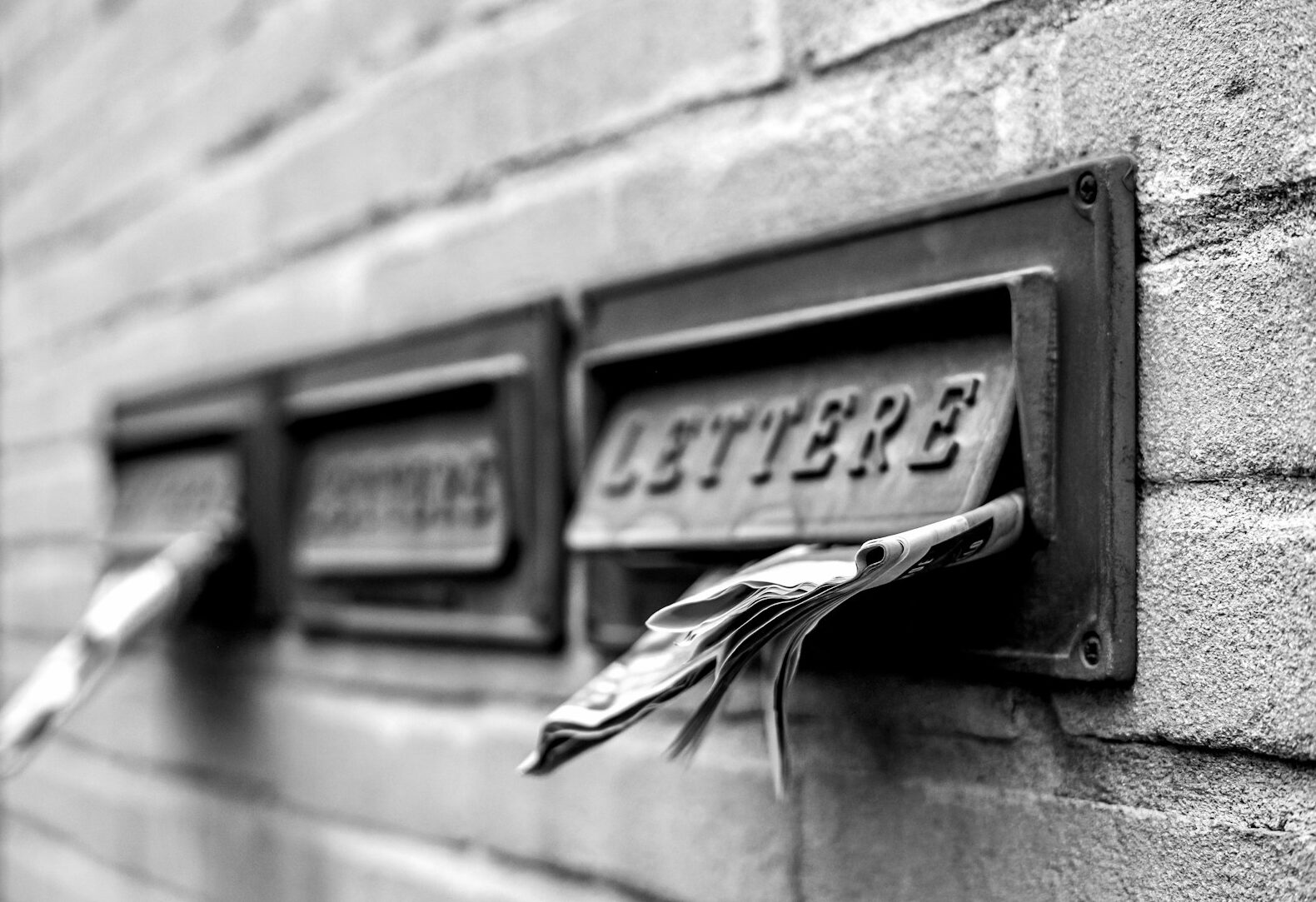 a close up of a mailbox on a brick wall